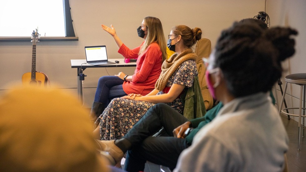 Tracie Potochnik gesturing at a screen while Morgan Johnston looks on