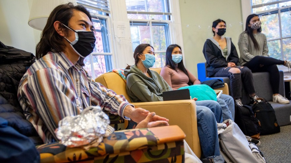 masked students sitting in a lounge room