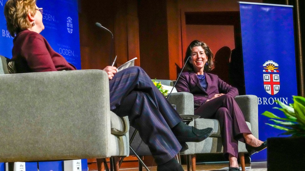 two people sitting in armchairs and speaking into microphones