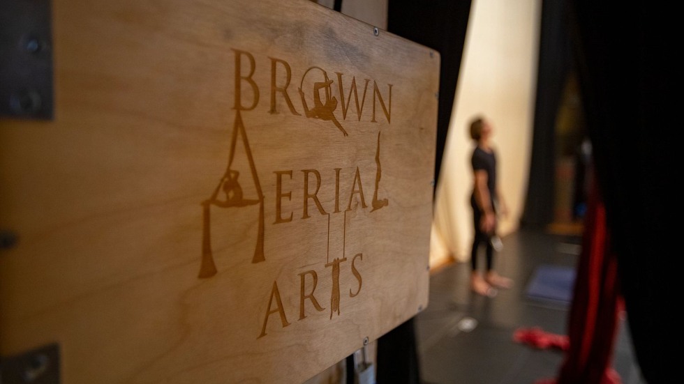 Wooden sign that says Brown Aerial Arts in stylized script