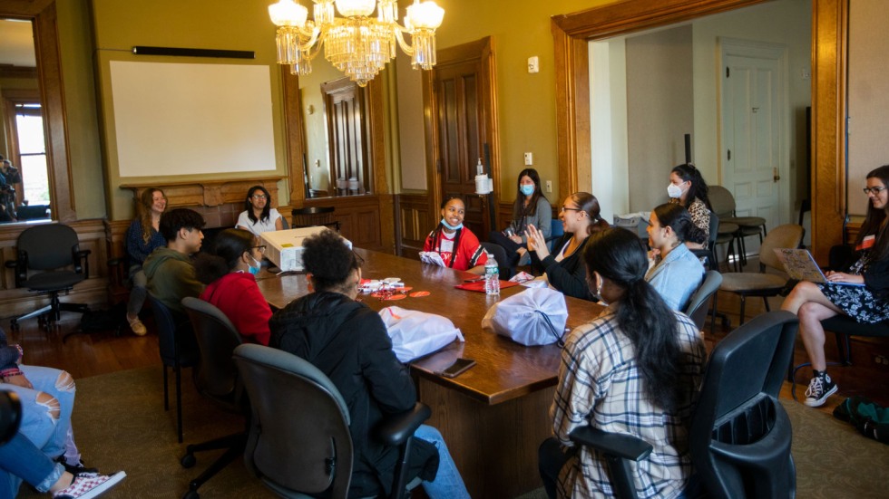 students sitting at a large table and talking