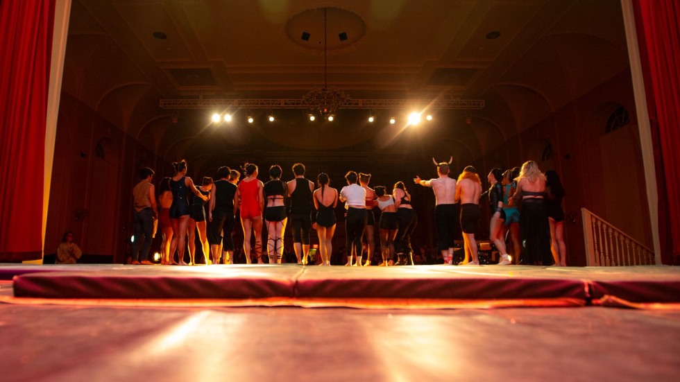 Students facing an audience on a stage