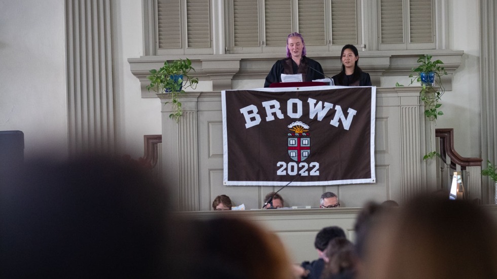 two people speaking from a pulpit in a church