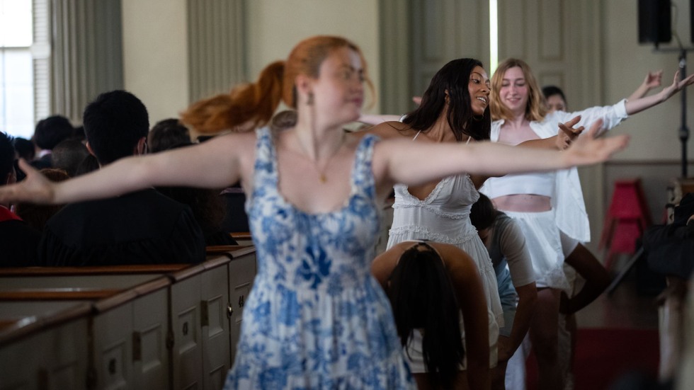 dancers extending their arms in a church aisle