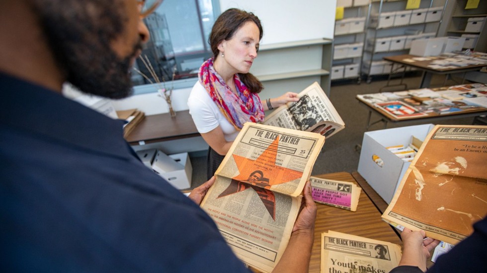 N'Kosi Oates reading a vintage Black Panther newspaper