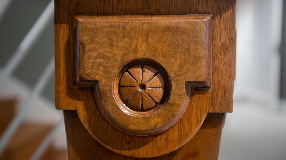 detailed carving on a wooden stair banister