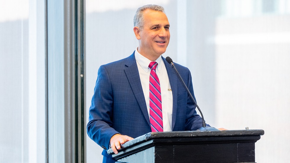 Mike Guglielmo speaks at a podium