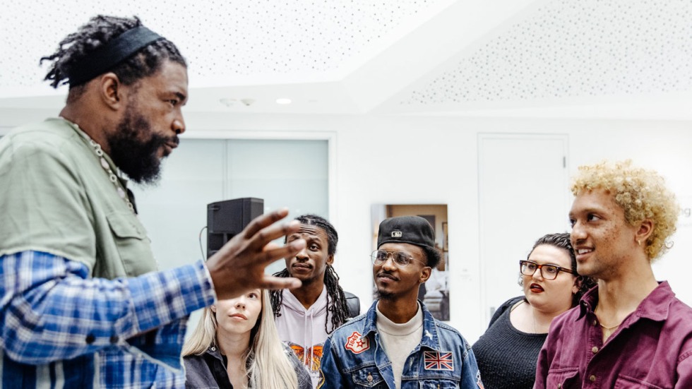 Questlove talking to a group of young people