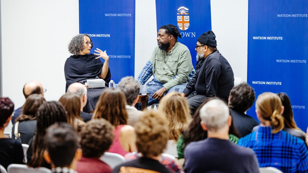 Tricia Rose, Questlove and Joseph Patel speaking at a podium in front of audience members