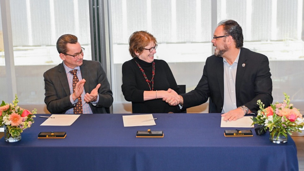 Andrew Cortes, President Paxson and Michael Sabitoni sign the MOU