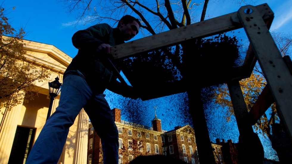 student sifting dirt on the Quiet Green at Brown University