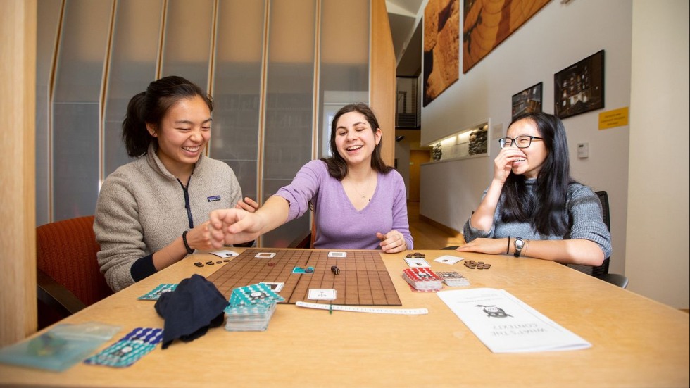 three people playing a board game