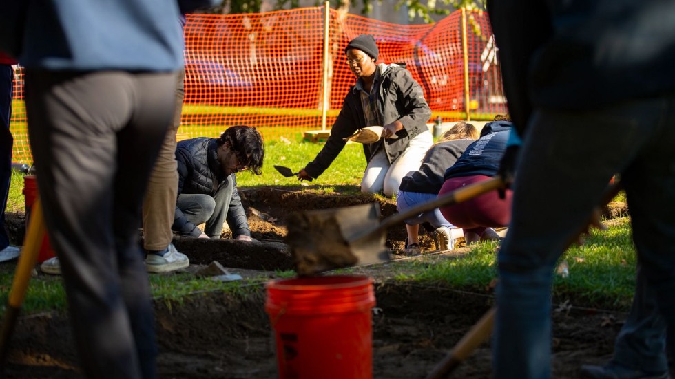 students digging at an archaeological site