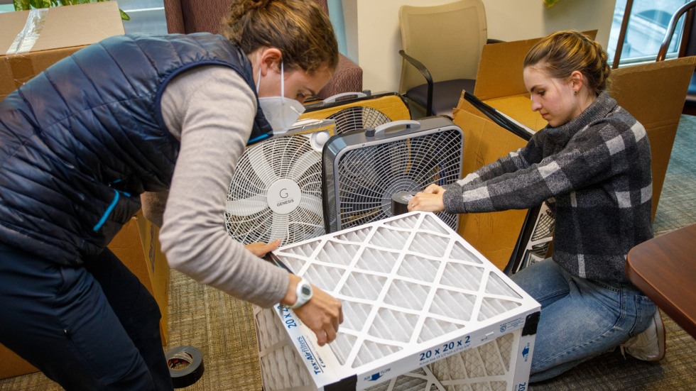 Student assembling Corsi-Rosenthal box