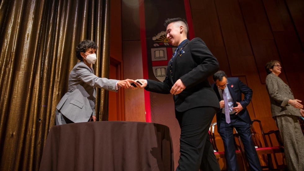 person handing an award to another person