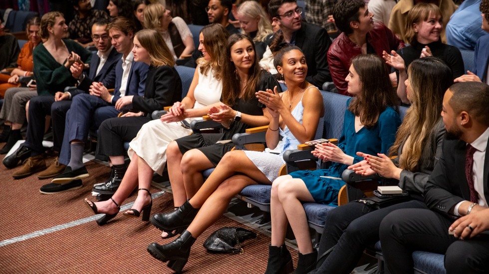 students sitting in the front row of an auditorium