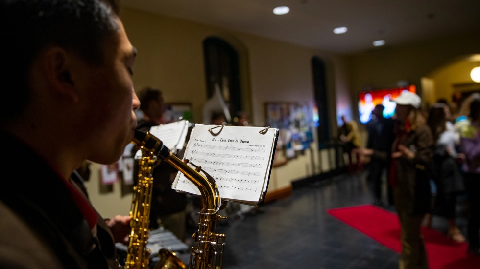 saxophonist performing from sheet music