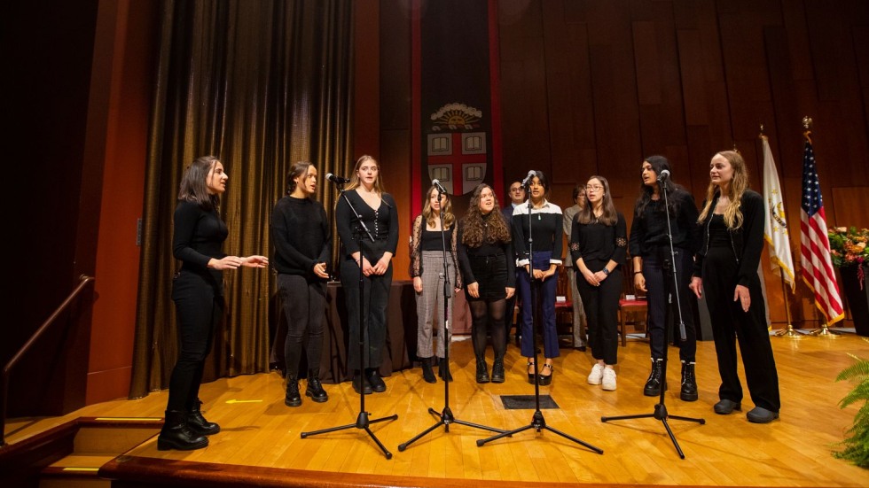 women's choir singing on a stage