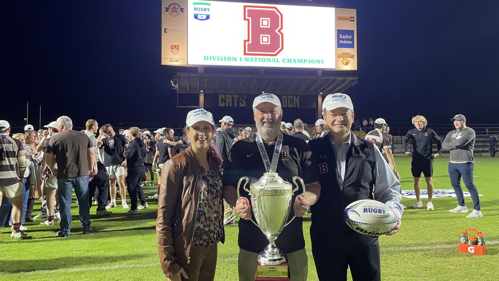 Grace Calhoun, Dave Laflammed and Samuel Mencoff pose with the trophy