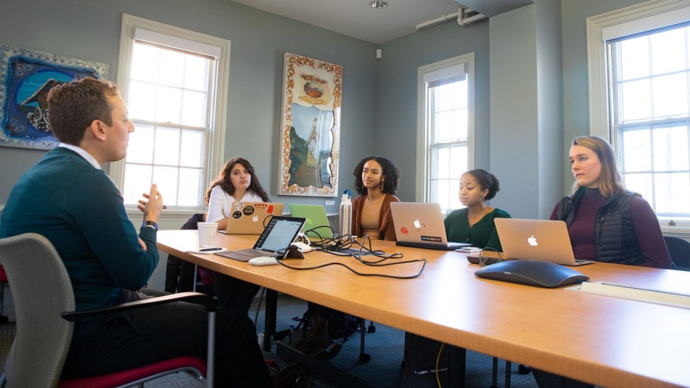 Zach Sell with Brown undergraduates in a conference room