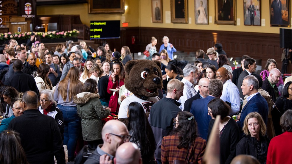 Bruno is surrounded by employees in Sayles Hall