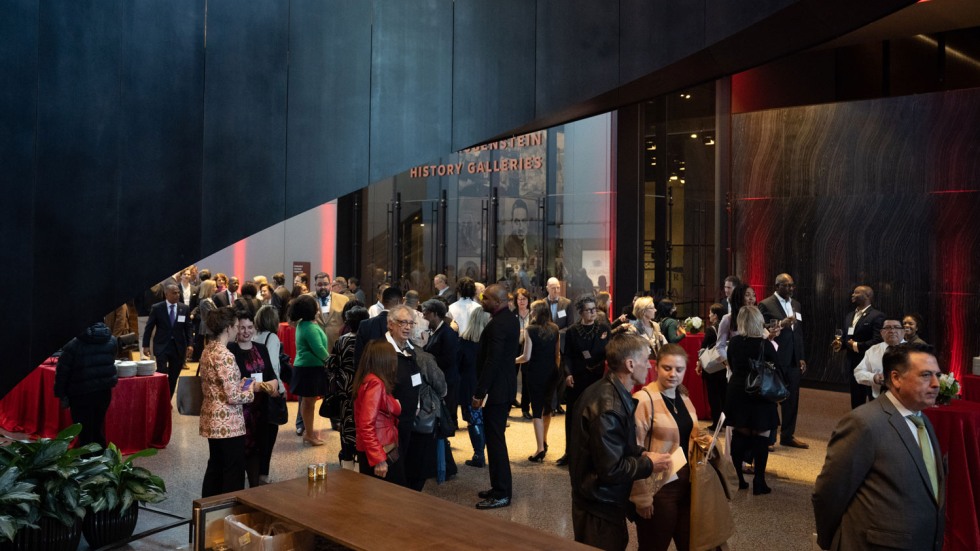 a crowd gathered for a reception at the National Museum of African American History and Culture