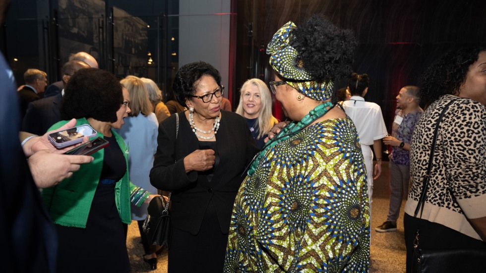 Ruth Simmons chatting with someone at a reception