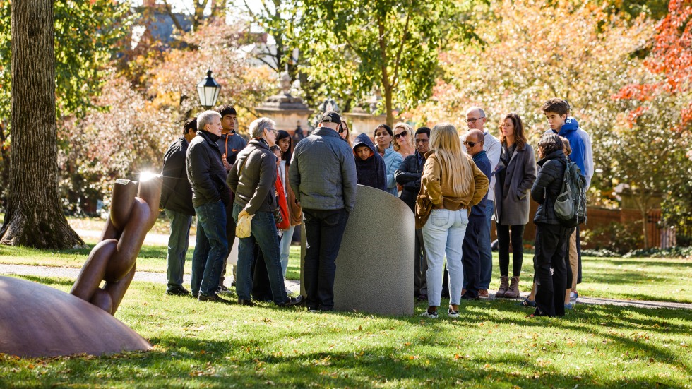 20 people gathered around Brown University's Slavery Memorial plinth