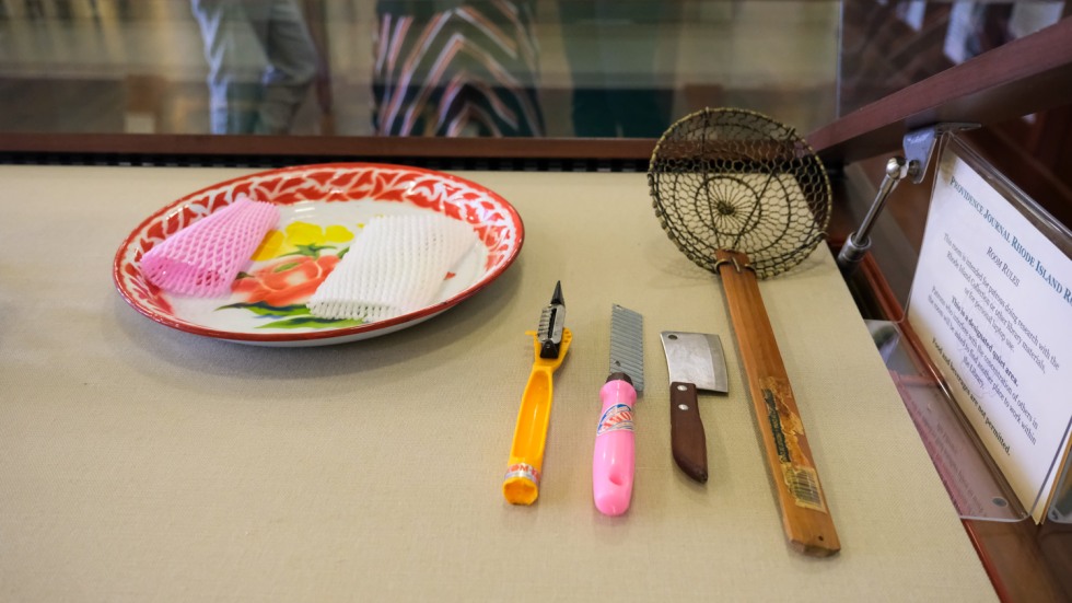 cooking and serving implements arranged in a display case