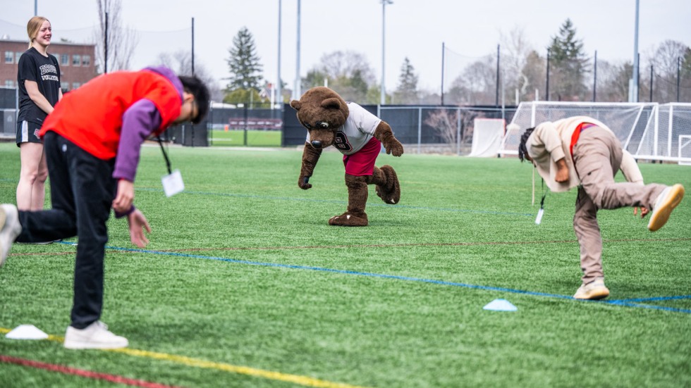 Bruno mascot exercising with students