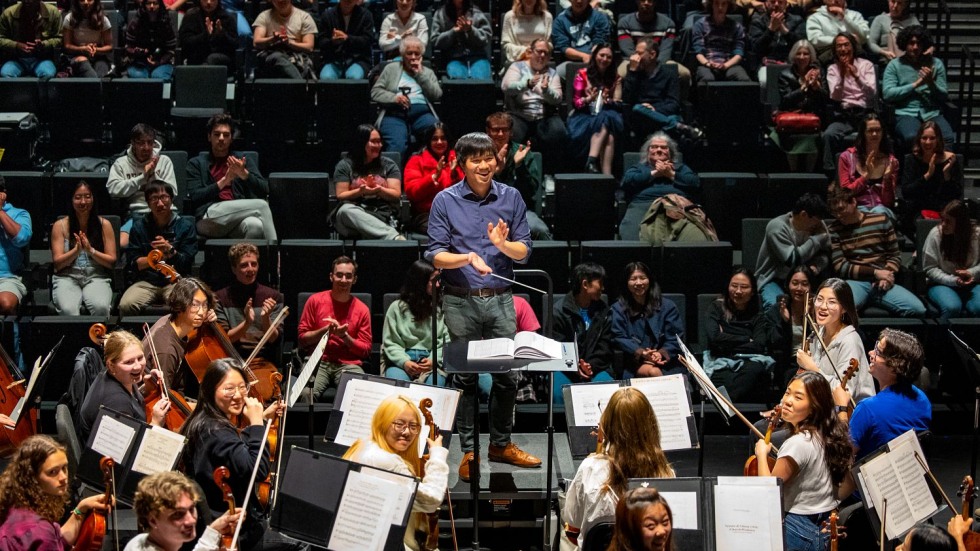 Mark Seto and members of the Brown Orchestra practicing in front of an audience