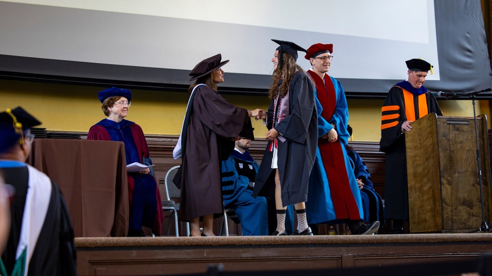 Student walking across stage