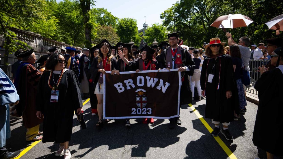 Graduates holding up a Brown 2023 sign