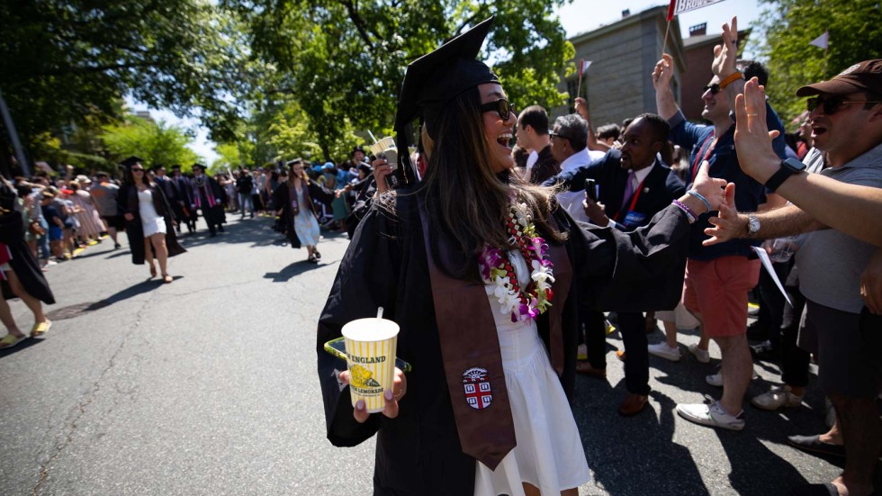 woman in a cap and gown holding a Del's Lemonade