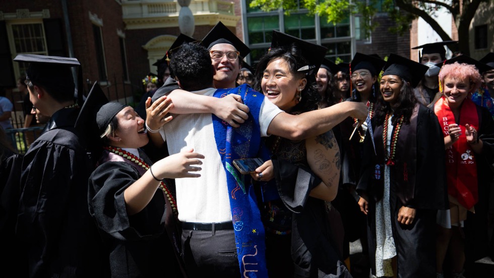 graduating students embracing