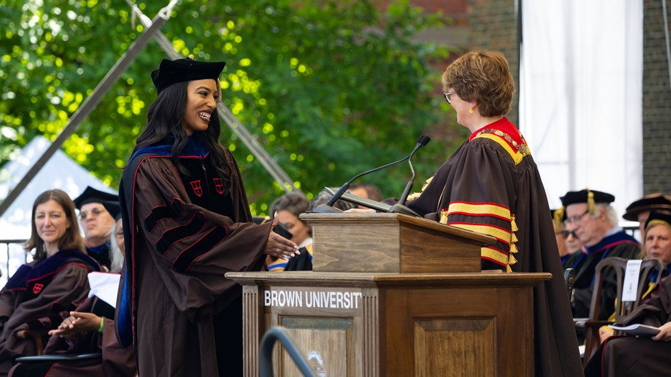 Kathryn Thompson shakes hands with Christina Paxson