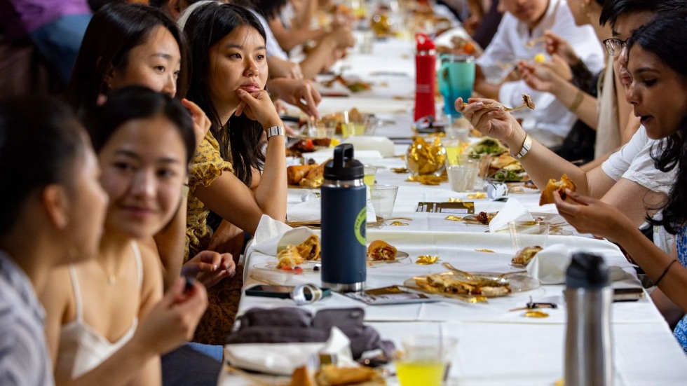 Students dine at banquet table