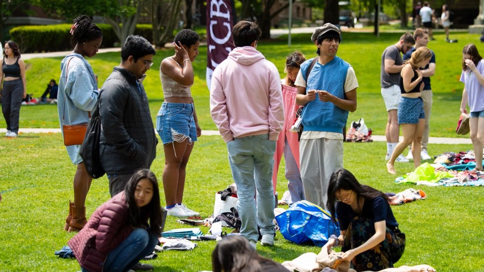 students look through clothes at the donation drive