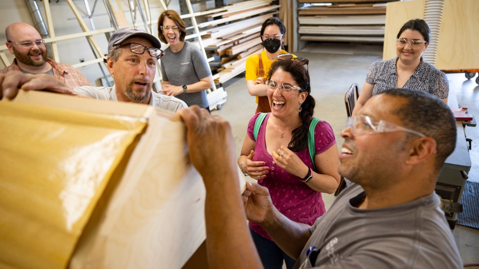 people work with equipment in the carpentry lab