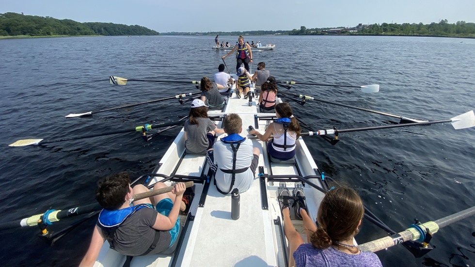 students learn to row on the barge