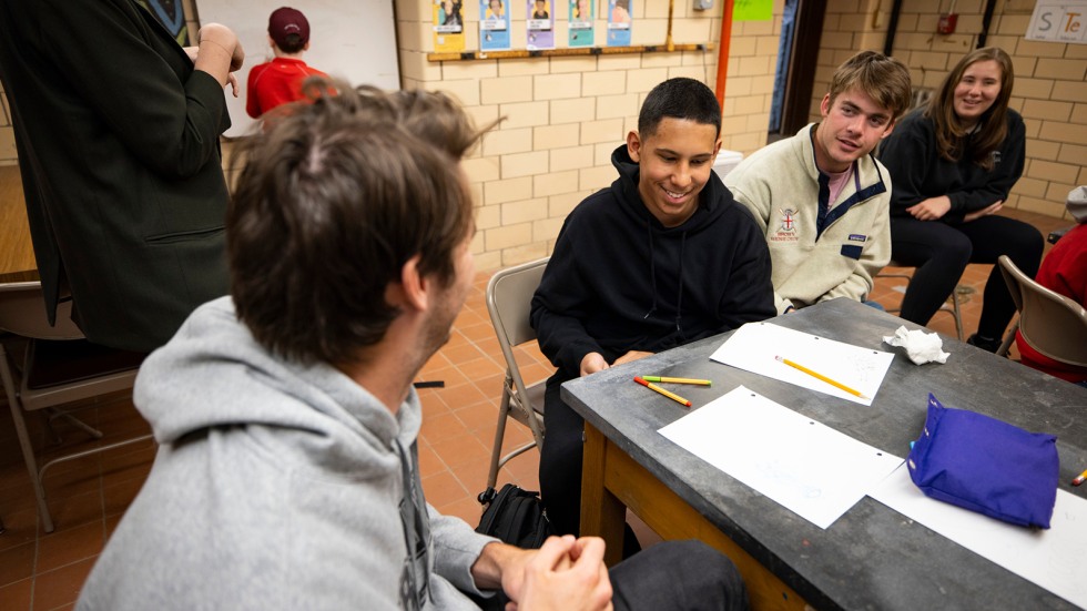 Crew members mentoring students 