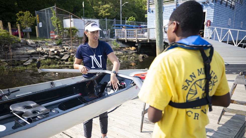 Brown student instructing middle school student