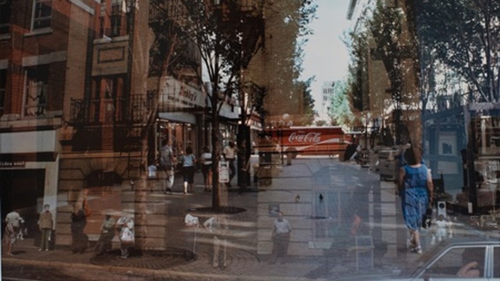 double exposed photograph of people walking down a busy block of Providence