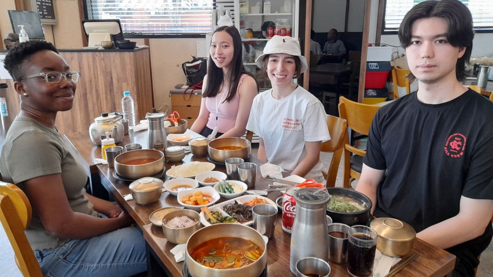 four students eating Dwaeji Gukbap