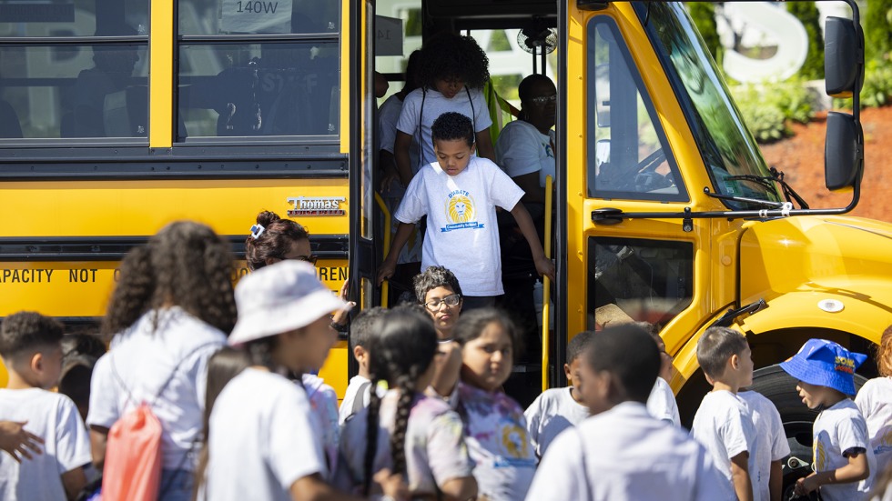 students leaving bus for field trip 