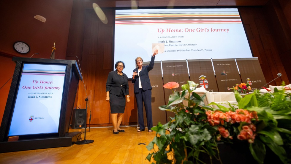 ruth simmons and christina paxson standing on a stage and waving