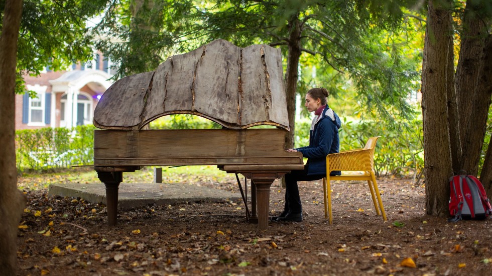 Devanney seated at the piano