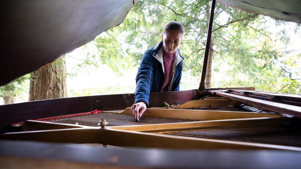 Devanney looks inside the piano