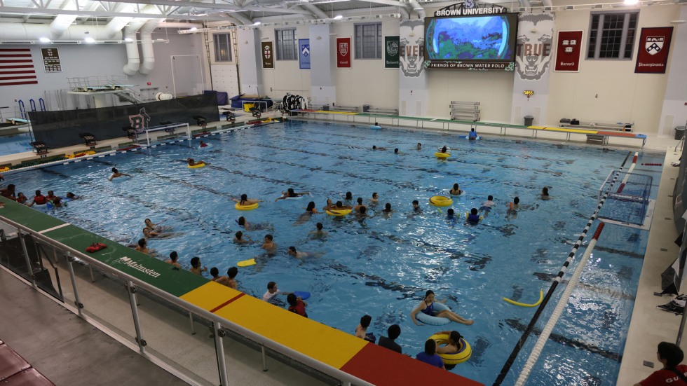 student watch The Little Mermaid in the gym pool on a dive-in movie night