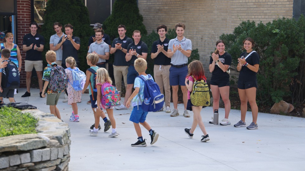 student-athletes welcome kids on first day of school